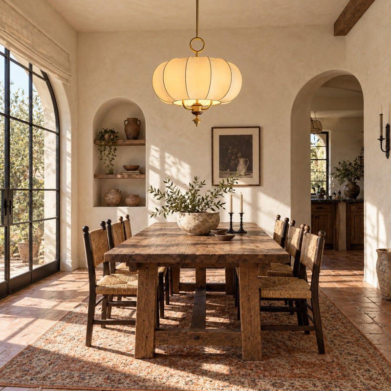 Belle lantern pendant casting a soft warm glow over an elegant dining table
