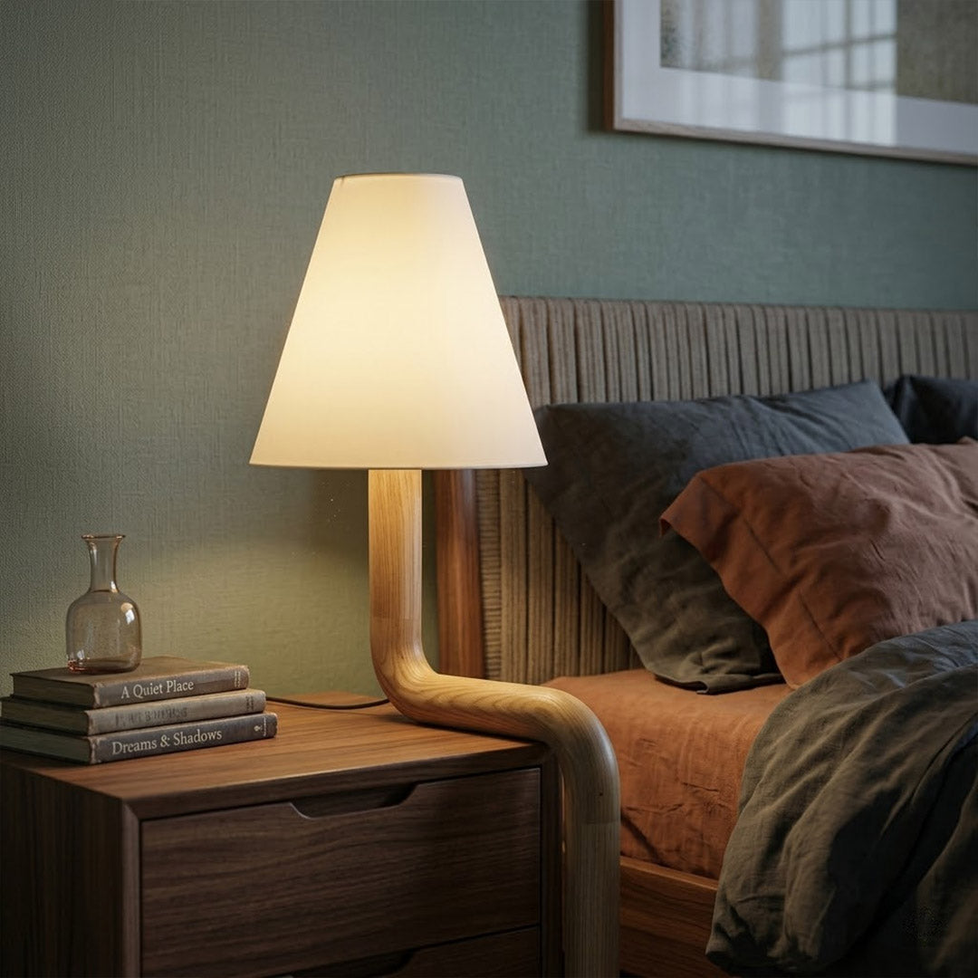 Modern bent wood table lamp with warm ambient LED lighting by Stuberlighting