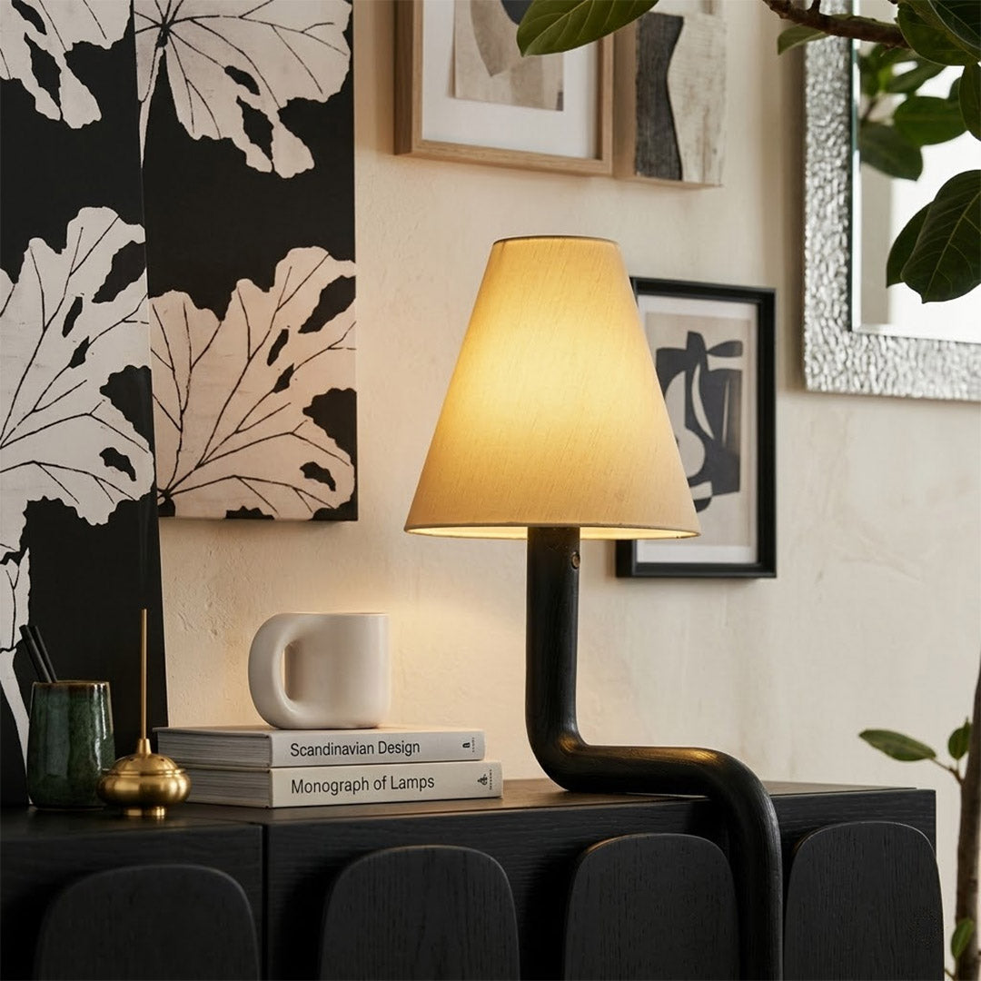 Modern bent wood table lamp with warm ambient LED lighting by Stuberlighting