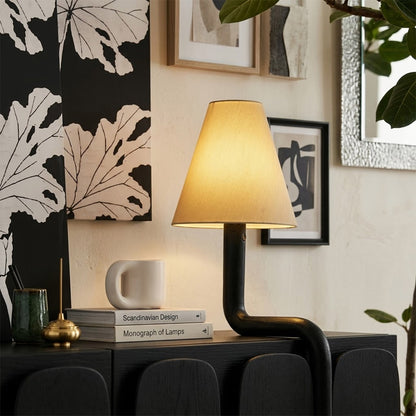Modern bent wood table lamp with warm ambient LED lighting by Stuberlighting