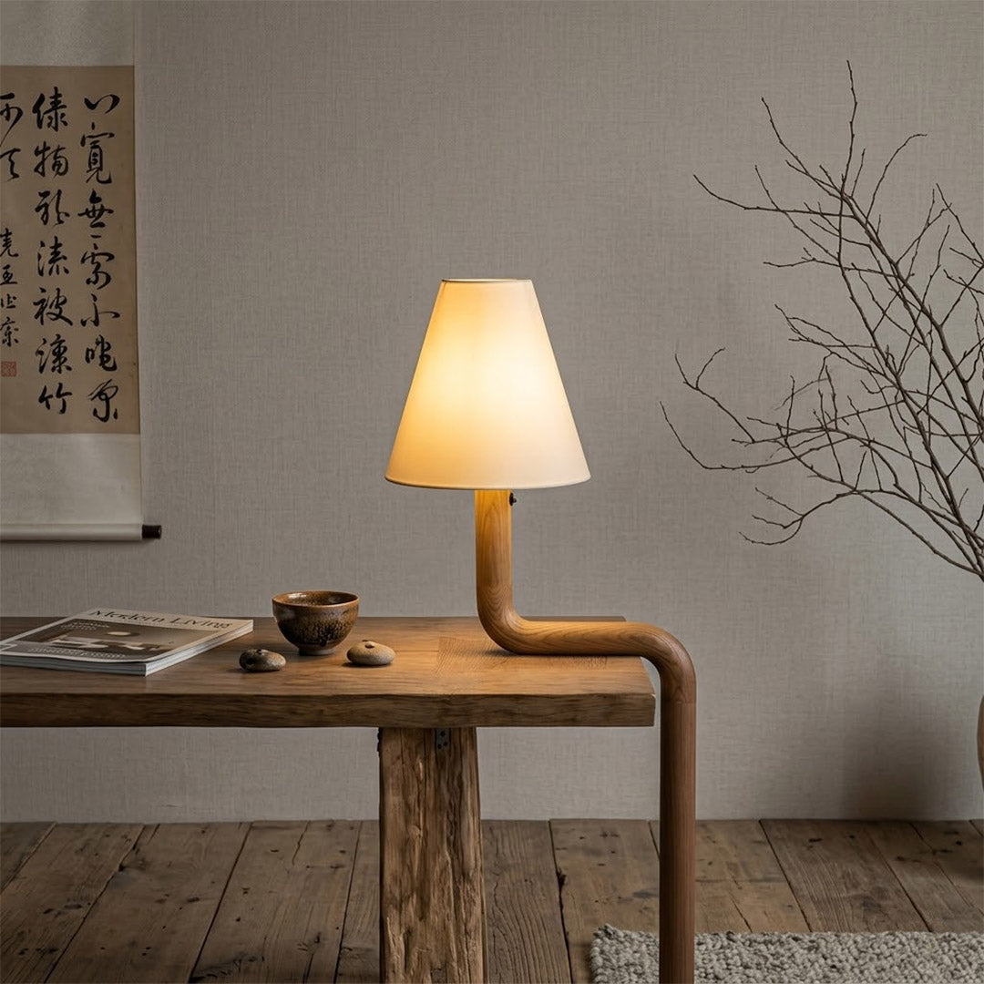 Modern bent wood table lamp with warm ambient LED lighting by Stuberlighting