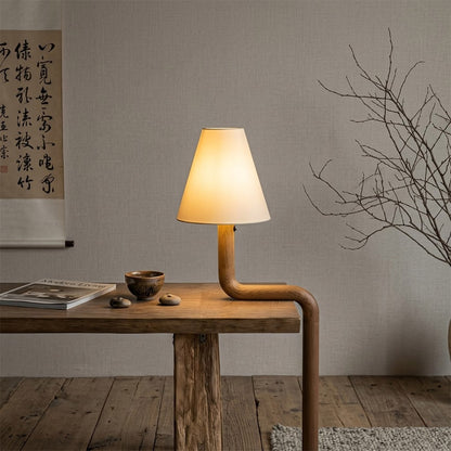Modern bent wood table lamp with warm ambient LED lighting by Stuberlighting