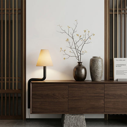 Modern bent wood table lamp with warm ambient LED lighting by Stuberlighting