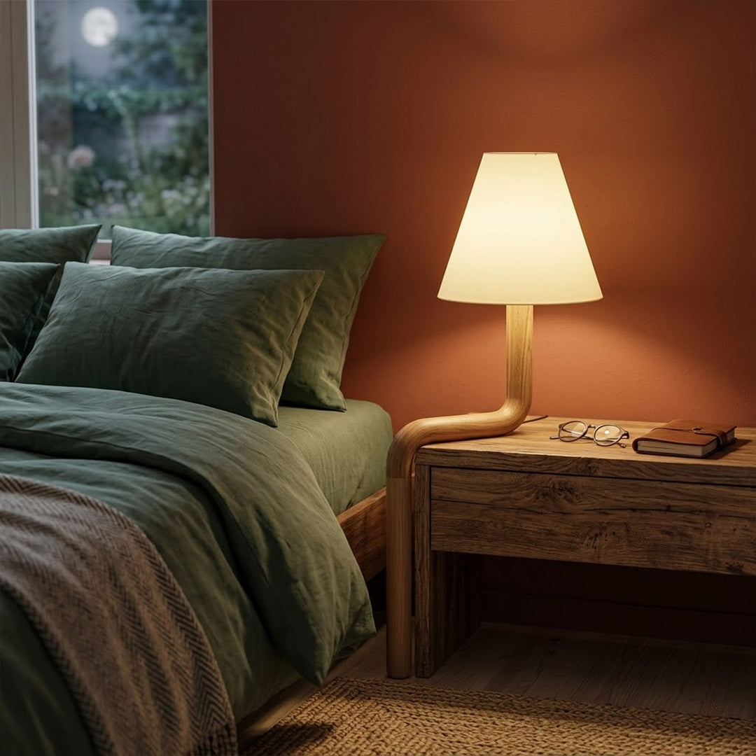 Modern bent wood table lamp with warm ambient LED lighting by Stuberlighting