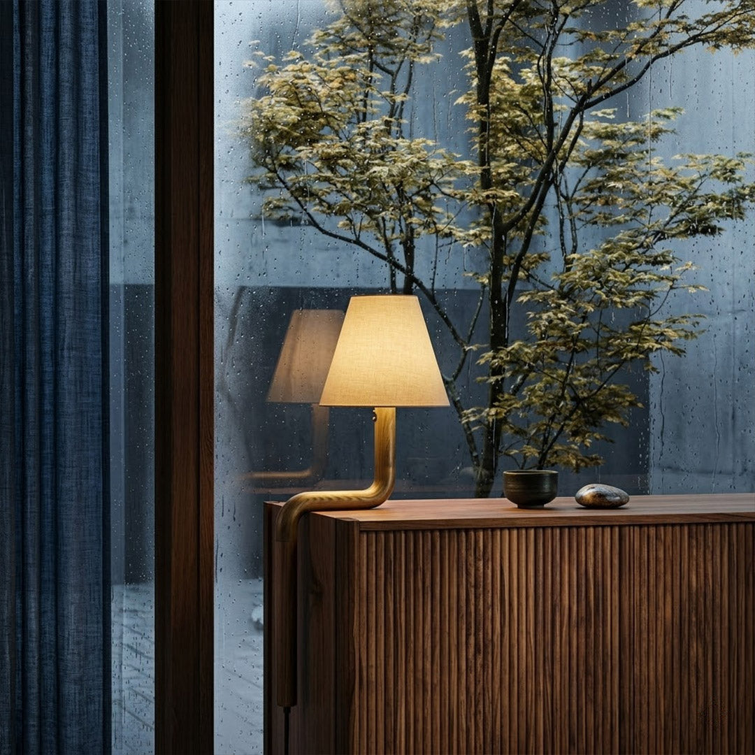 Modern bent wood table lamp with warm ambient LED lighting by Stuberlighting