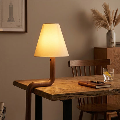 Modern bent wood table lamp with warm ambient LED lighting by Stuberlighting