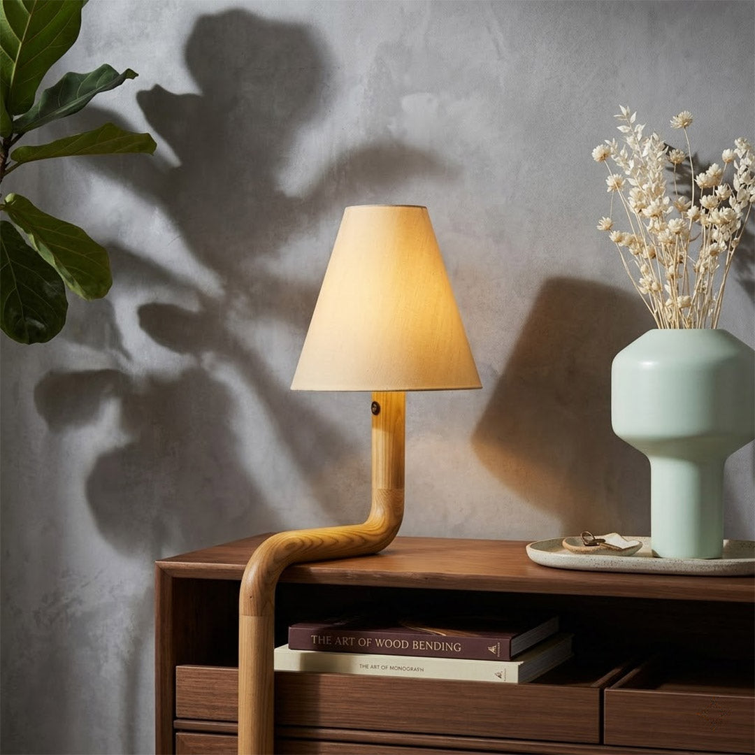 Modern bent wood table lamp with warm ambient LED lighting by Stuberlighting