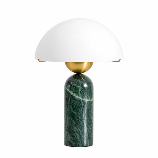 Boccia table lamp with a white alabaster sphere base and gold accents glowing on a nightstand