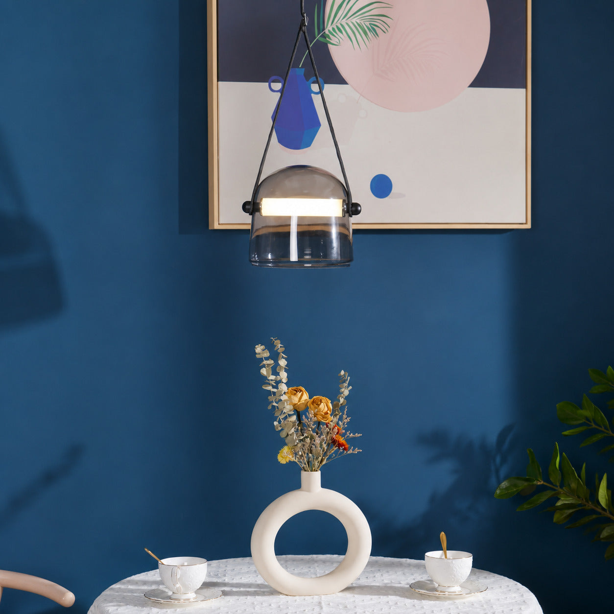 Bolla glass pendant light dining table bar top illuminated warm glow glass leather strap American home lifestyle interior styled