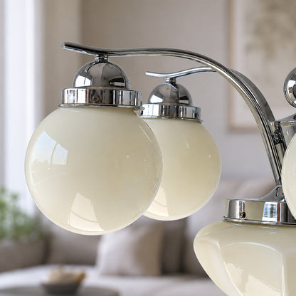 Close-up of the rounded opal glass globe shades on the Bolla chandelier diffusing a soft glow