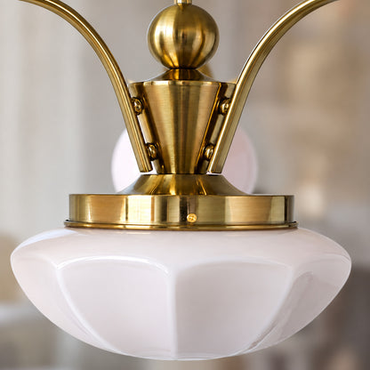Close-up of the rounded opal glass globe shades on the Bolla chandelier diffusing a soft glow