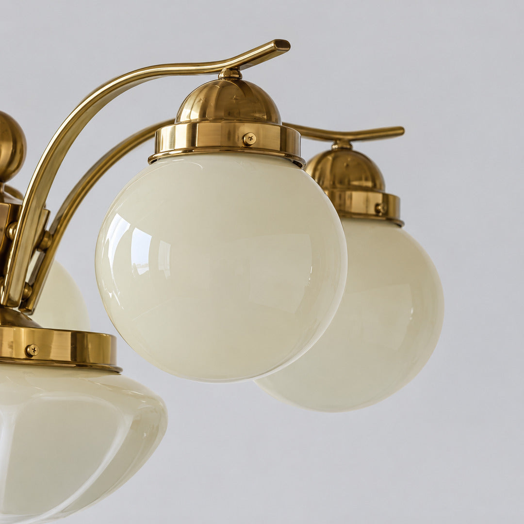 Detail of the curved multi-arm metal frame of the Bolla glass chandelier