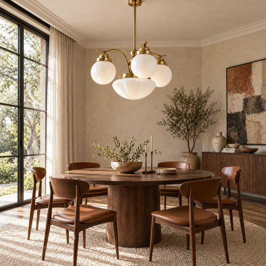 Bolla globe glass chandelier casting warm light over a mid-century dining room table