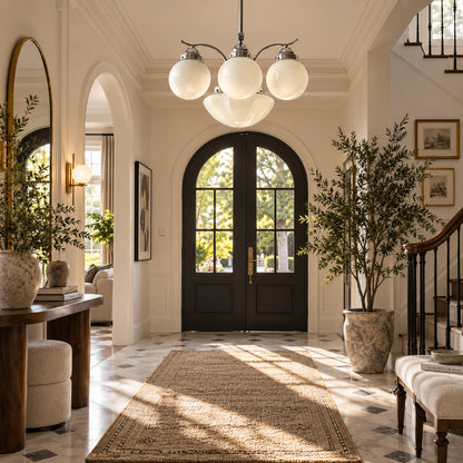 Bolla globe glass chandelier welcoming guests with a warm retro glow in an entryway