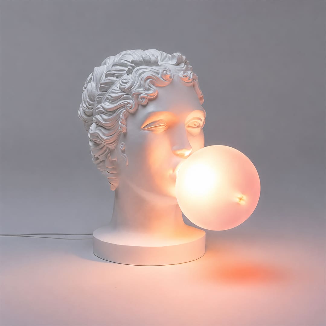 Bolla table lamp illuminated warm glow through pink bubble gum glass shade evening pop art playful whimsical mood setter detail close up