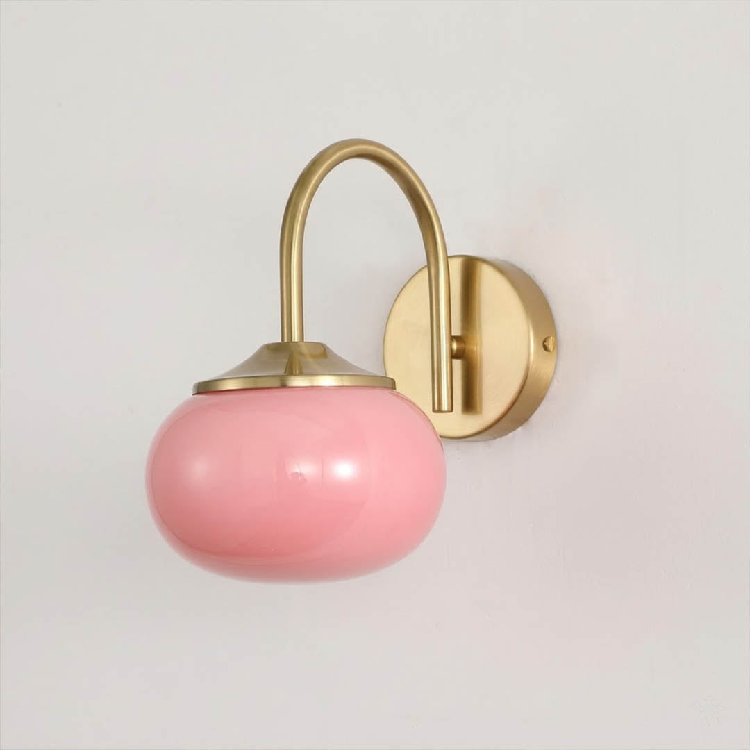 Bonbon wall sconce antique brass bow pink glass globe vintage white background