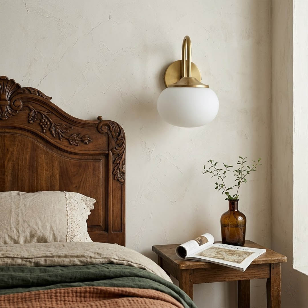 Bonbon wall sconce pair flanking bed pink glass globe warm glow bedroom interior