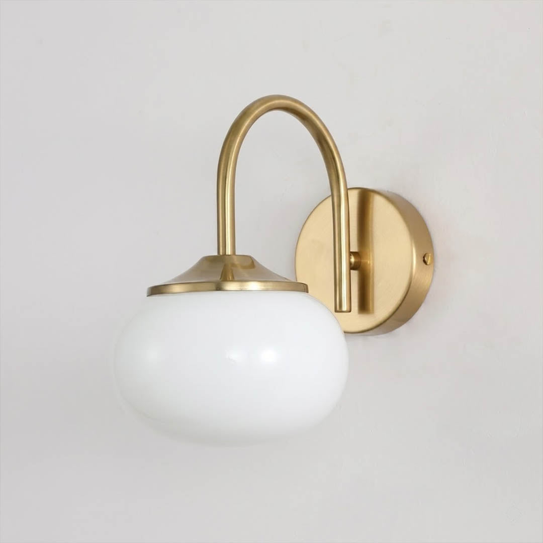 Bonbon wall sconce antique brass bow white glass globe vintage white background
