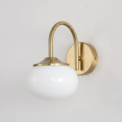 Bonbon wall sconce antique brass bow white glass globe vintage white background