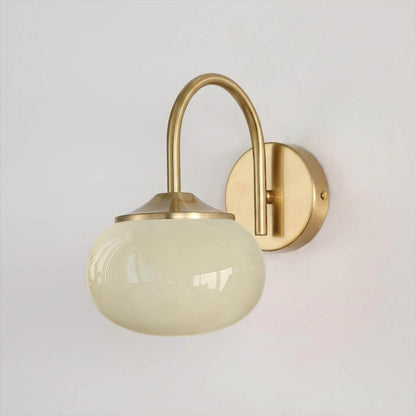 Bonbon wall sconce antique brass bow beige glass globe vintage white background