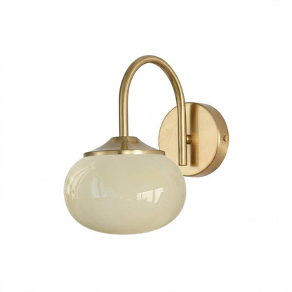 Bonbon wall sconce antique brass bow beige glass globe vintage white background