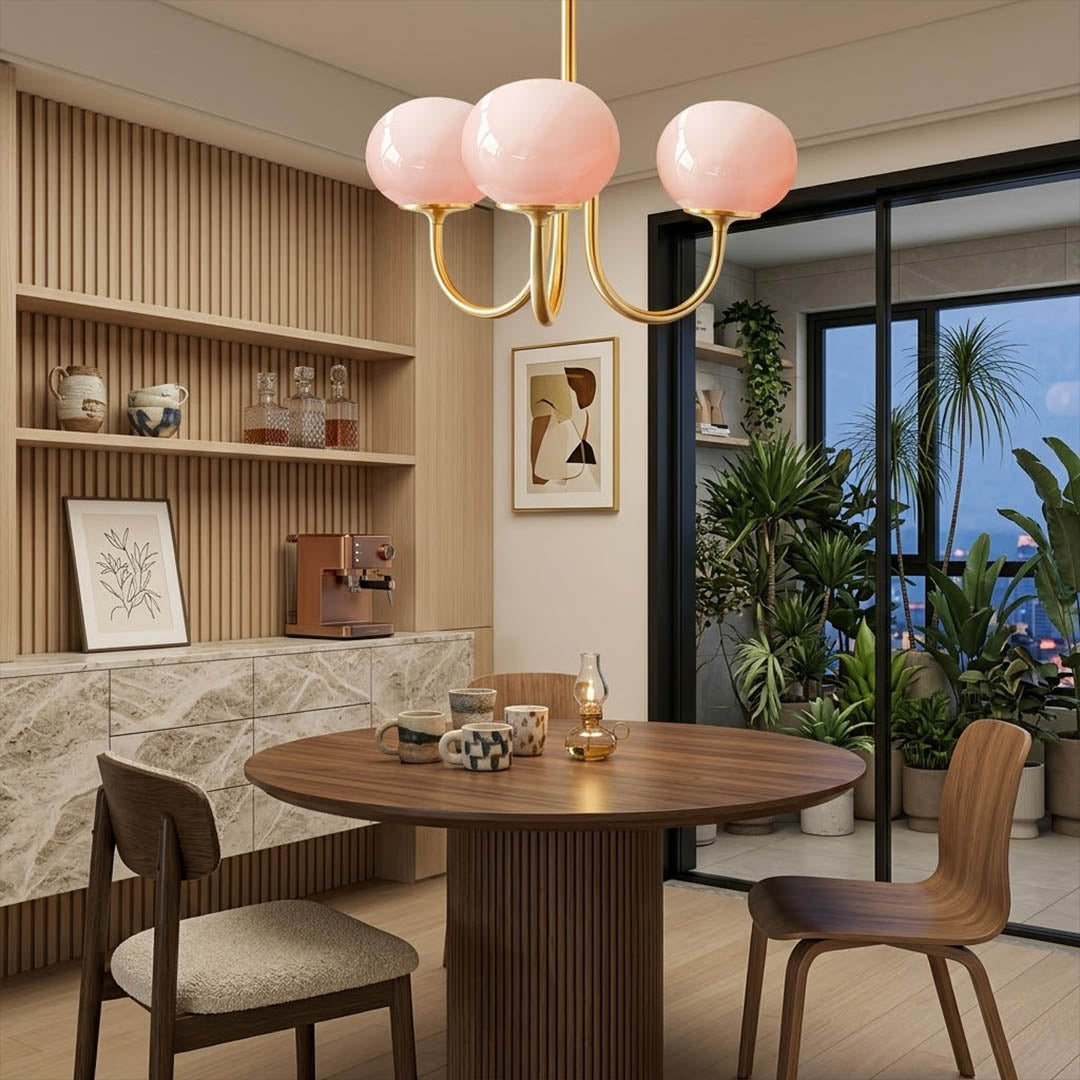Bonbon glass globe chandelier above dining table warm glow modern interior