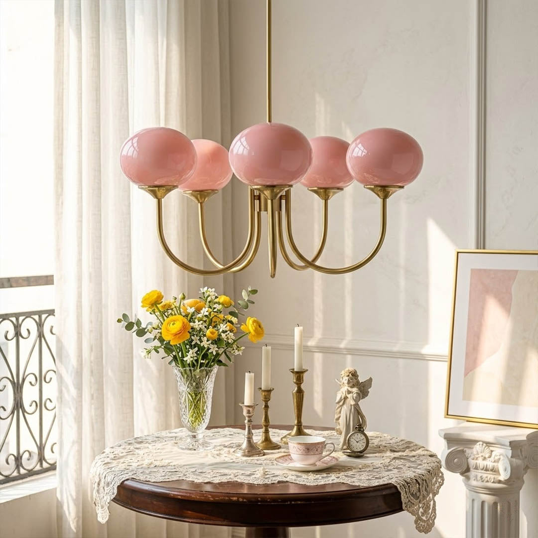 Bonbon glass globe chandelier above dining table warm glow modern interior