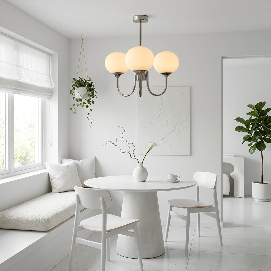 Bonbon glass globe chandelier above dining table warm glow modern interior