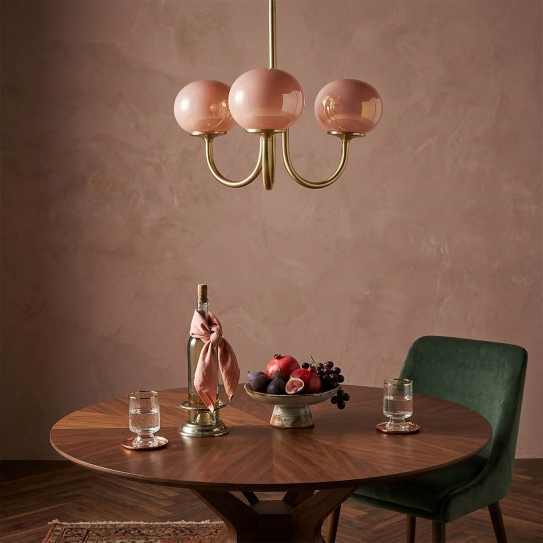Bonbon glass globe chandelier above dining table warm glow modern interior