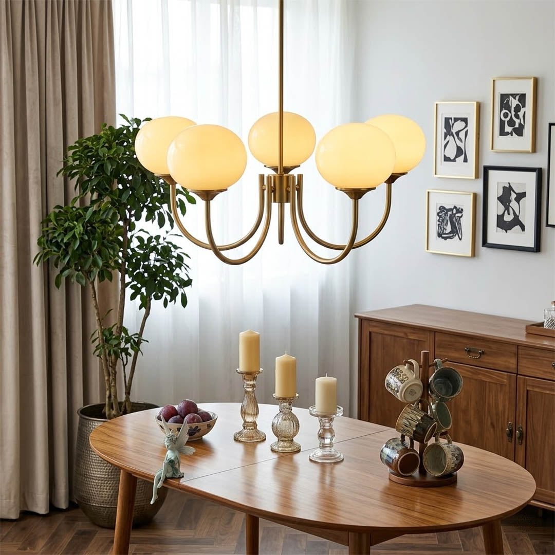 Bonbon glass globe chandelier above dining table warm glow modern interior