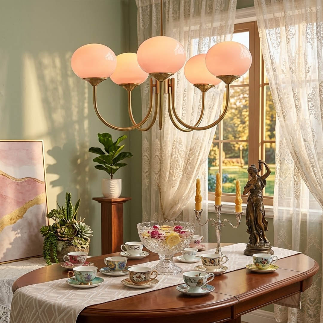 Bonbon glass globe chandelier above dining table warm glow modern interior