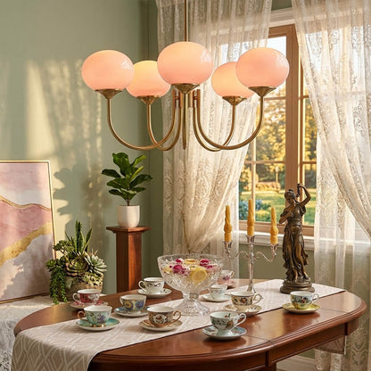 Bonbon glass globe chandelier above dining table warm glow modern interior