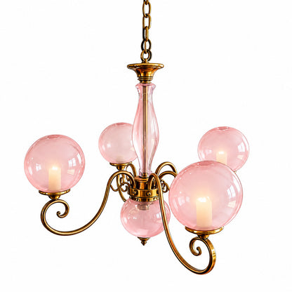 Five-light pink Boule glass chandelier centered above a dining table