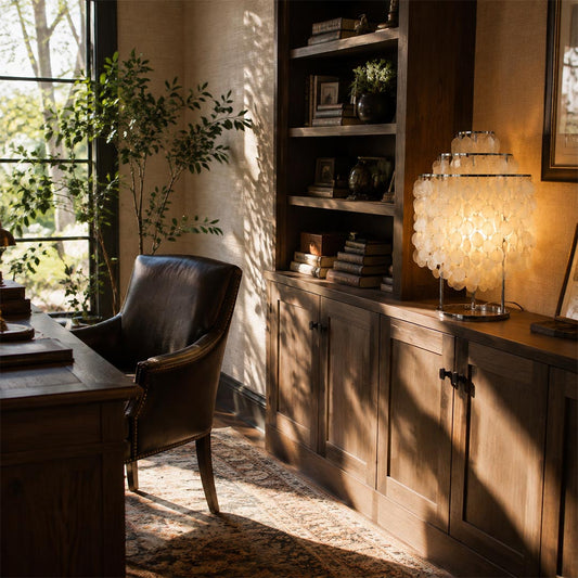 Illuminated shell cluster table lamp creating a cozy atmosphere in a dark wood home office setup