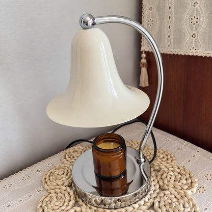 Campana candle warmer lamp creating a cozy scented atmosphere in a corner reading nook