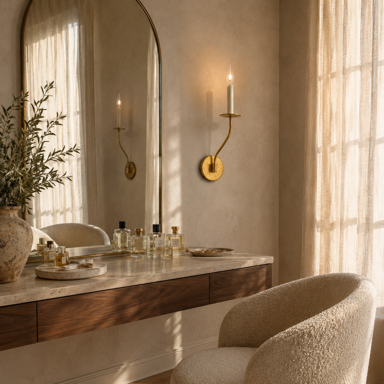 Candela wall sconce either side vanity dressing mirror bedroom warm flattering glow aged brass candle style American home lifestyle interior styled