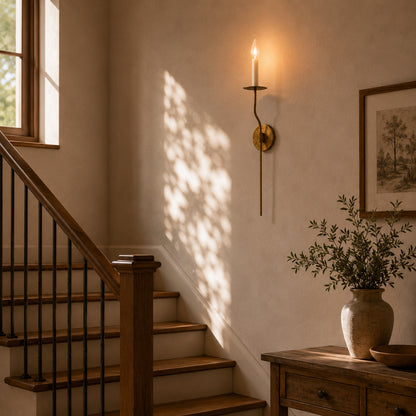 Candela wall sconce staircase stairwell stairway wall ascending warm glow aged brass candle style American home lifestyle interior styled