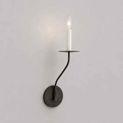 Candela wall sconce short single light matte black finish candle style exposed E14 bulb compact arm round backplate minimalist white background front view