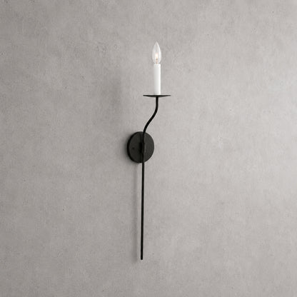 Candela wall sconce tall single light matte black finish candle style exposed E14 bulb slim curved arm round backplate minimalist vintage white background front view