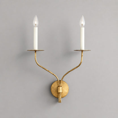 Candela wall sconce two light aged brass finish candle style dual exposed E14 bulbs curved twin arms wide round wall plate vintage mid century white background front view