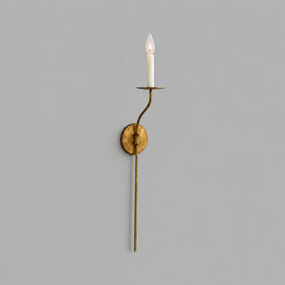 Candela wall sconce tall single light aged brass finish candle style exposed E14 bulb slim curved arm round wall plate vintage mid century white background front view