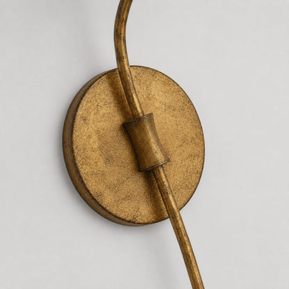Candela wall sconce aged brass distressed antique finish patina texture surface detail close up craftsmanship