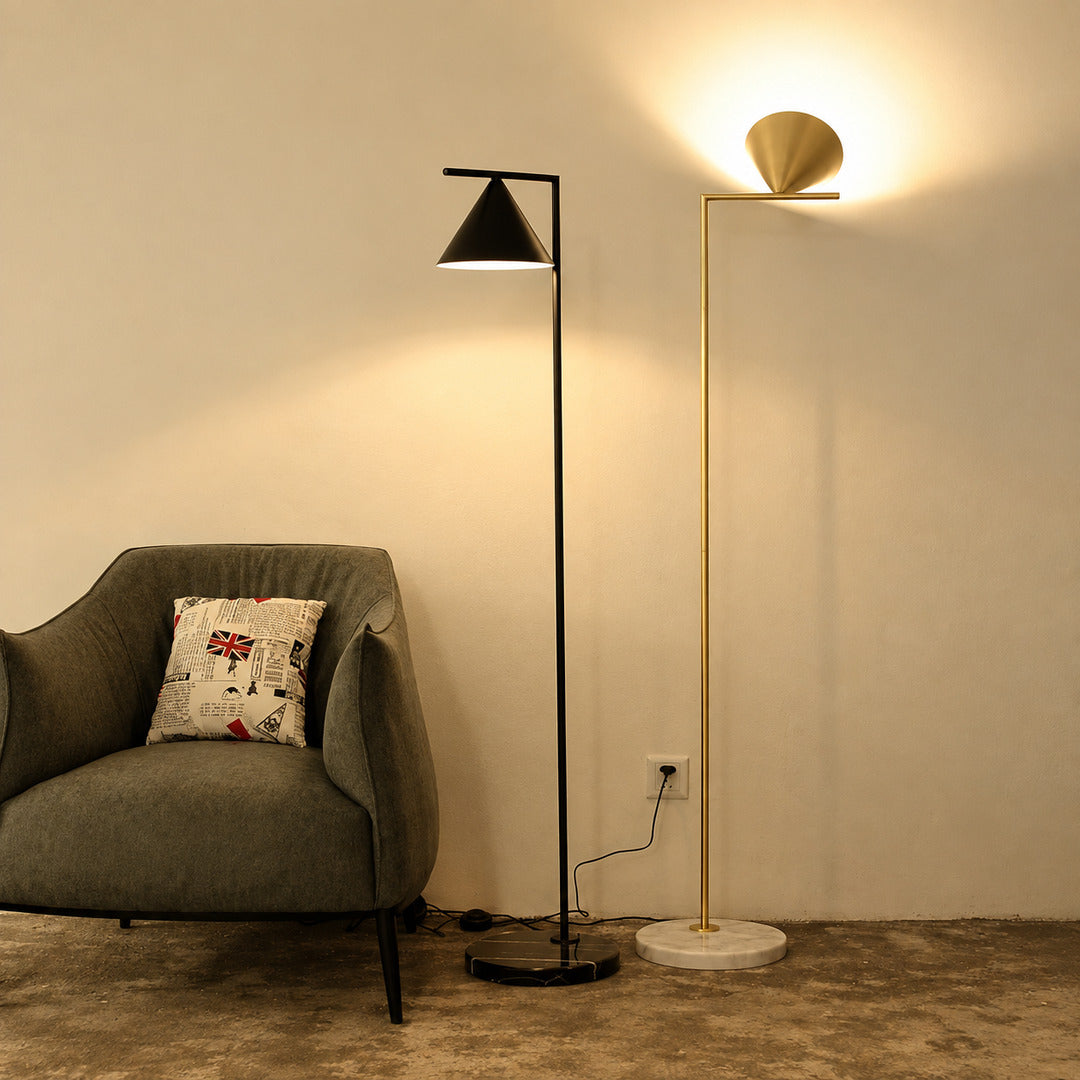 Girevole marble floor lamp angled over an armchair to direct warm reading light in a corner