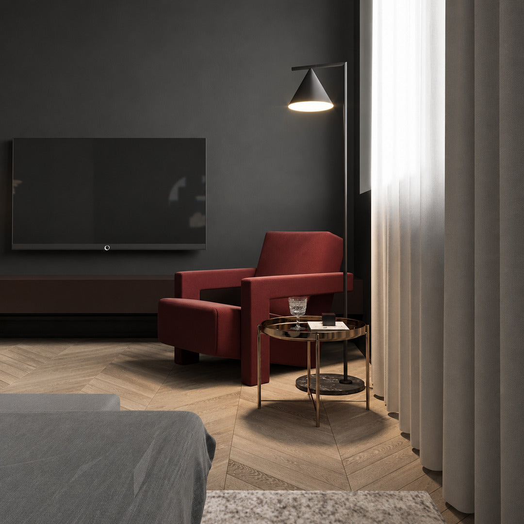 Girevole marble floor lamp angled over an armchair to direct warm reading light in a corner