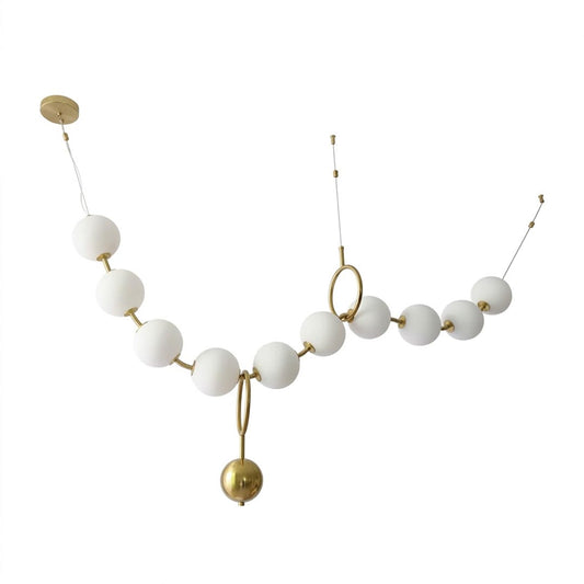Cascadia linear horizontal chandelier 10-light brass arc pearl globes white background