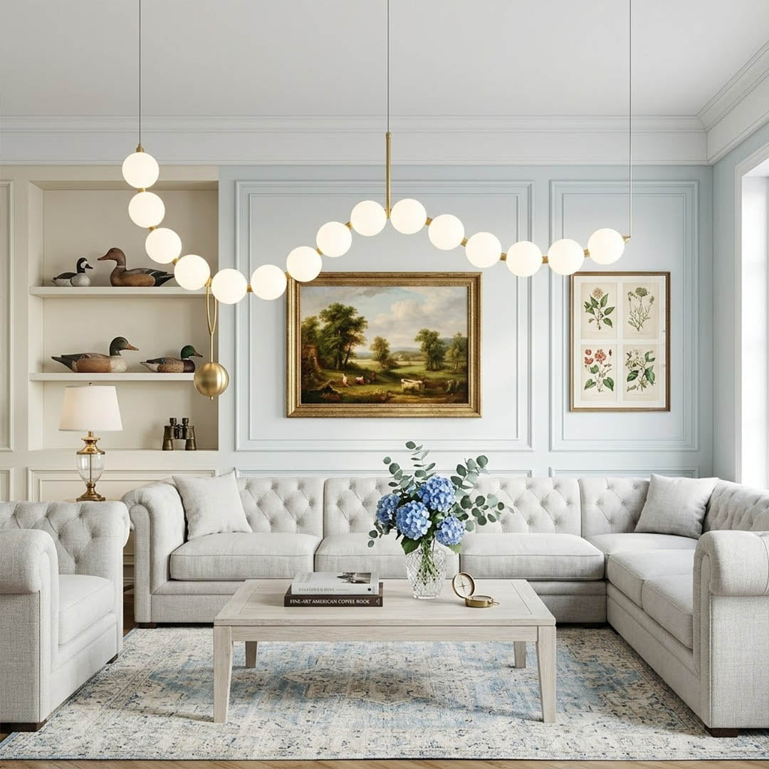 Cascadia horizontal chandelier above long dining table pearl globes warm glow elegant interior