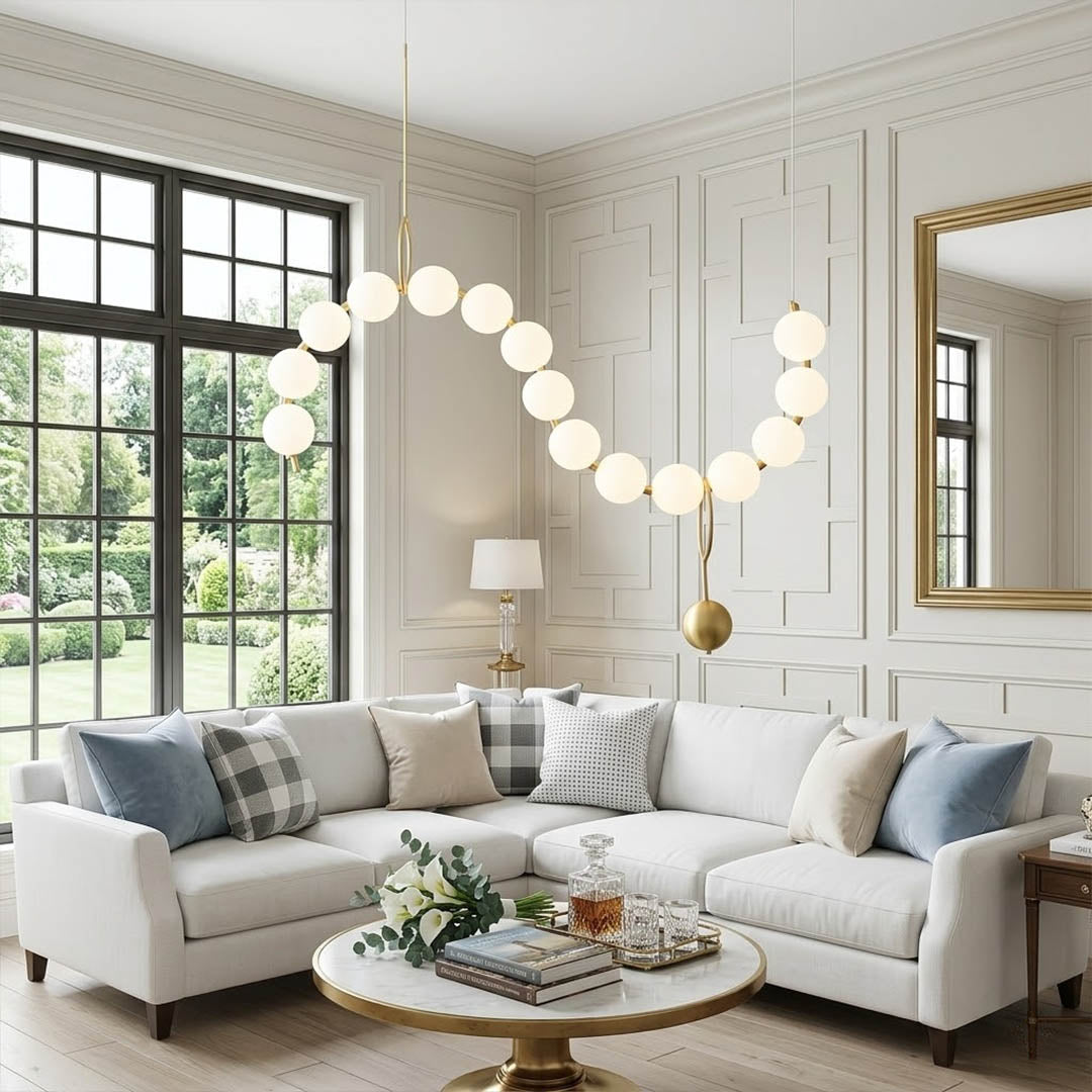 Cascadia horizontal chandelier above long dining table pearl globes warm glow elegant interior
