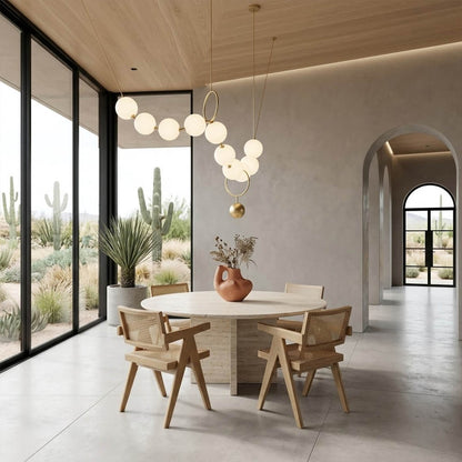 Cascadia horizontal chandelier above long dining table pearl globes warm glow elegant interior