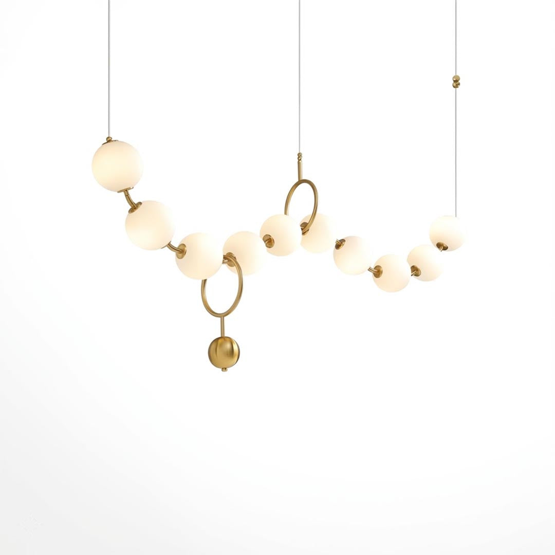 Cascadia linear horizontal chandelier 10-light brass arc pearl globes white background