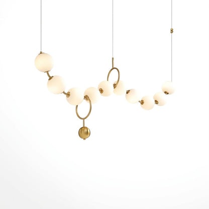 Cascadia linear horizontal chandelier 10-light brass arc pearl globes white background